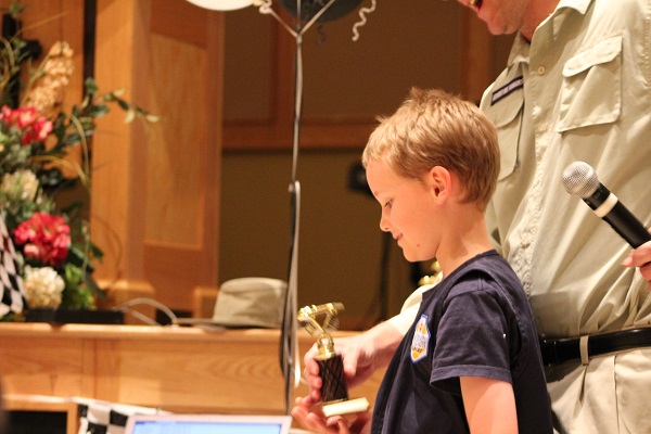 Asher receiving his trophy